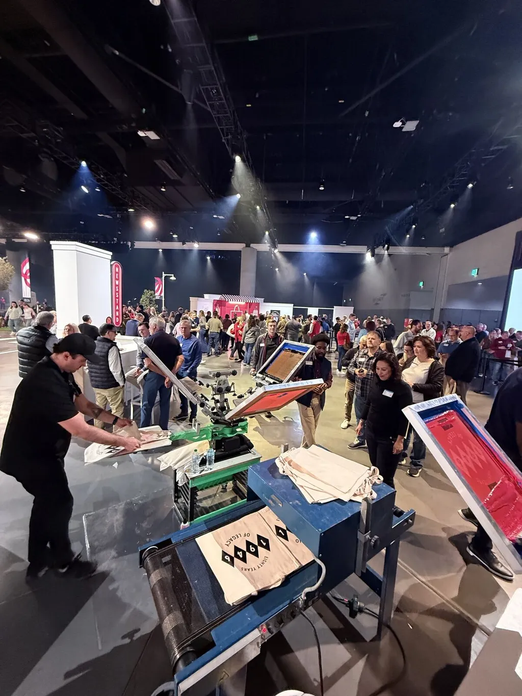 Guests around a Merch Troop live customization station